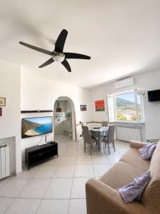 a living room with a couch and a ceiling fan at Appartamento Casa di Sole Ischia in Ischia Town