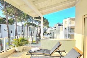 a pair of chairs on a balcony at Perla Penthouse - Happy Rentals in Mullini i Danit +32 photos