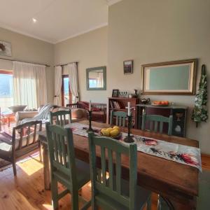 a kitchen and dining room with a table and chairs at Zion's Rest in Barrydale