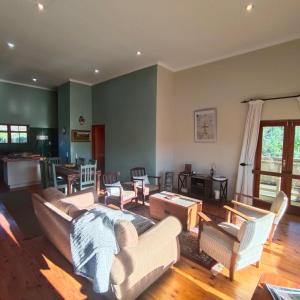 a living room with a couch and chairs and a table at Zion's Rest in Barrydale
