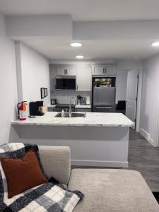 a kitchen with a sink and a counter top at A very cozy 2-bedroom apartment in Calgary