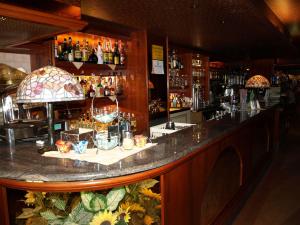 a bar with a counter with a lot of drinks at Hotel Karol in Monza