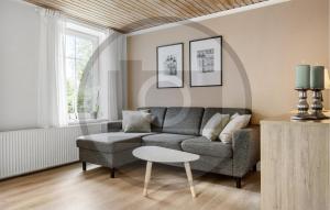 a living room with a couch and a table at 2 Bedroom Nice Apartment In Skanderborg in Skanderborg