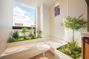 a room with two stools and a window with plants at Mumum Jongno in Seoul
