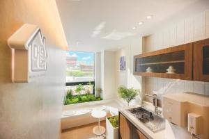 a kitchen with a window with a view of a city at Mumum Jongno in Seoul +22 photos