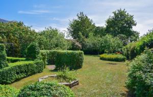 a garden with bushes and hedges and trees at 3 Bedroom Pet Friendly Home In Löderup in Löderup