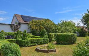 a garden with trimmed hedges and a house at 3 Bedroom Pet Friendly Home In Löderup in Löderup