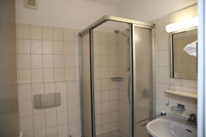 a bathroom with a shower and a sink at Hotel Garni Alte Post in Schallbach