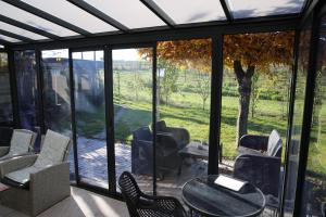 a screened in porch with a table and chairs at Hotel Garni Alte Post in Schallbach