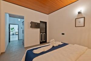 a bedroom with a large bed with a wooden ceiling at Heritage Villa - 05 Bedroom Family Villa in Central Ahangama in Ahangama