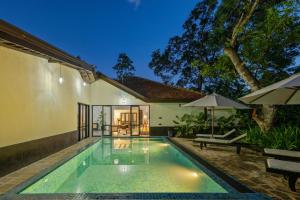 a swimming pool in the backyard of a house at Heritage Villa - 05 Bedroom Family Villa in Central Ahangama in Ahangama