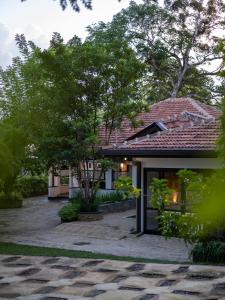 a house with a brick patio in front of it at Heritage Villa - 05 Bedroom Family Villa in Central Ahangama in Ahangama