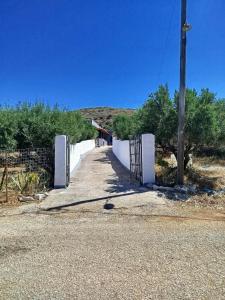 a gate on the side of a road at Mani GuestHouse in Kyparissos