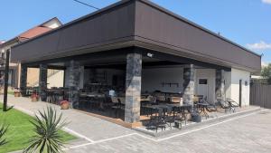 a black building with tables and chairs in it at Luna in Solotvyno