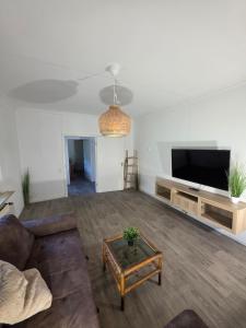 a living room with a couch and a table at Ferienhaus Löwe in Niedenstein