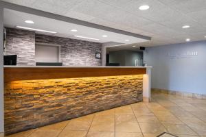 a bar in a lobby with a brick wall at AmericInn by Wyndham Madison West in Madison +35 photos