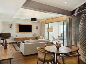 a living room with a couch and a table at Hilton Hotel Tahiti in Papeete