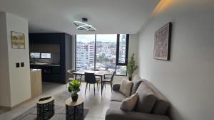 a living room with a couch and a table at Adagio Quito Coliving Ecuador Residences in Quito
