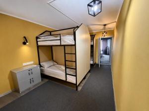 a room with two bunk beds and a hallway at Joy Fergana Guesthouse in Fergana