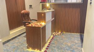 a room with a chair and a desk with lights at Hotel Prisha Recidency in Wardha