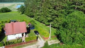 an aerial view of a house with a car parked in the yard at Dom Na Mazurach in Przerwanki