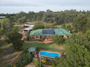 an aerial view of a house with a swimming pool at Pericoe Retreat in Dubbo