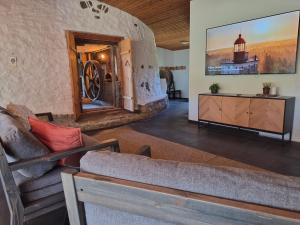 a living room with a couch and a large wall at Partsi Veski in Partsi