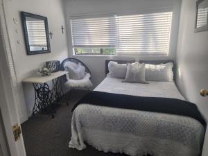 a bedroom with a large bed and a window at Darlene's Nest in Cable Bay +19 photos