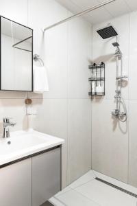 a white bathroom with a sink and a shower at Green House -მწვანე სახლი in Tsalka +12 photos