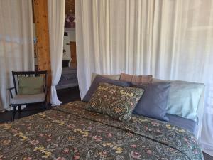 a bedroom with a bed and a chair at Partsi Veski in Partsi