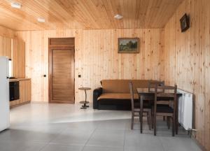 a kitchen with a table and a couch in a room at Green House -მწვანე სახლი in Tsalka