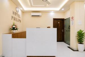 an office lobby with a reception desk and a door at Hotel Philips in Kolkata