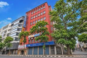a red building on the side of a street at Hotel Philips in Kolkata