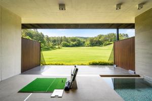 a view of a golf course from inside a house at Haeundae Beach Restfield in Busan