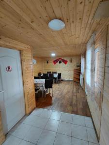 a room with a dining room with a table at Cabanutele Geo in Lacu Rosu
