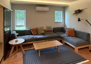 a living room with a couch and a table at u10 -ユーテン- in Kakegawa