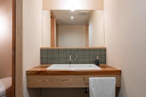 a bathroom with a sink and a mirror at u10 -ユーテン- in Kakegawa +31 photos