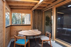 a room with a table and chairs and a window at u10 -ユーテン- in Kakegawa