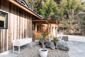 a house with a bench next to a building at u10 -ユーテン- in Kakegawa