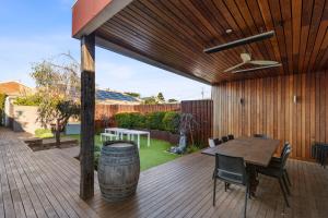 a wooden deck with a table and a barrel at BIG4 Ingenia Holidays Queenscliff Beacon in Queenscliff