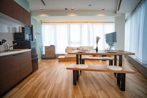 a kitchen with a table and a living room at ORI Ikebukuro in Tokyo +18 photos