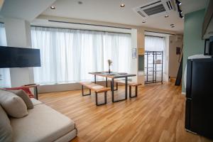 a living room with a couch and a table at ORI Ikebukuro in Tokyo