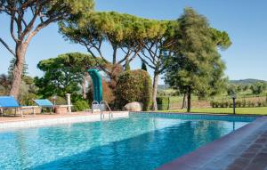 a swimming pool with trees and a water slide at Awesome Apartment In Roccastrada in Roccastrada