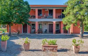 an orange house with trees in front of it at Awesome Apartment In Roccastrada in Roccastrada
