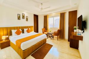 a hotel room with a bed and a television at Hotel La Casa, Amritsar #swimming pool #prime location #luxury rooms #best selling hotel near golden temple in Amritsar