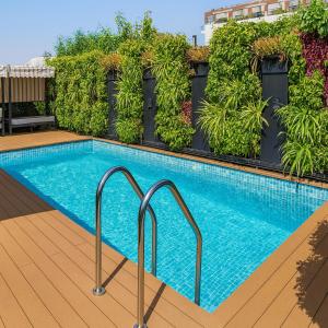 a swimming pool with plants on a building at Hotel La Casa, Amritsar #swimming pool #prime location #luxury rooms #best selling hotel near golden temple in Amritsar