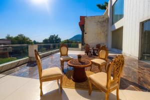 a group of chairs and a table on a balcony at Hotel La Casa, Amritsar #swimming pool #prime location #luxury rooms #best selling hotel near golden temple in Amritsar