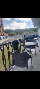 a balcony with a table and a table and chairs at Alvina complex in Tsaghkadzor