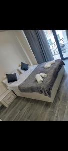 a bedroom with a large bed with blue pillows at Alvina complex in Tsaghkadzor