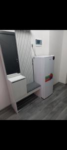 a white refrigerator and a chair in a room at Alvina complex in Tsaghkadzor